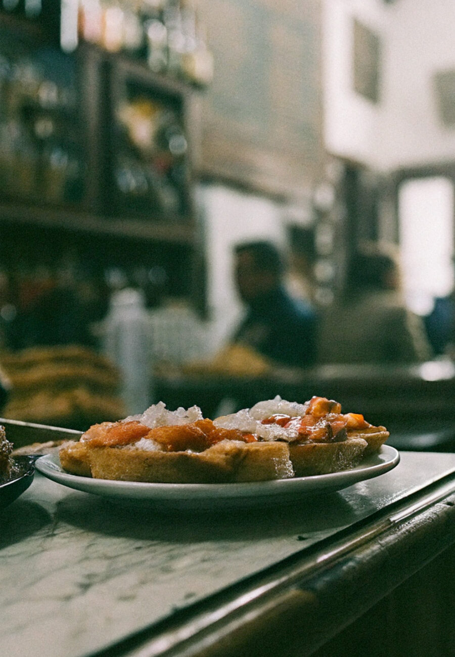 Vibrant tapas tour in Granada, Spain, featuring an array of traditional Spanish small plates and lively street scenes perfect for foodie adventures.